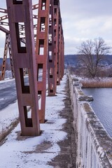 Metal construction of the old bridge across the river. Elements of the metal construction of the...