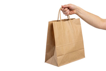 Hand holding kraft paper bag isolated on transparent background