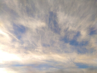 Serene, ethereal cloudscape. Soft, diffused light bathes delicate wispy clouds against a pale blue sky. Ideal for backgrounds, websites, travel, or naturethemed projects.
