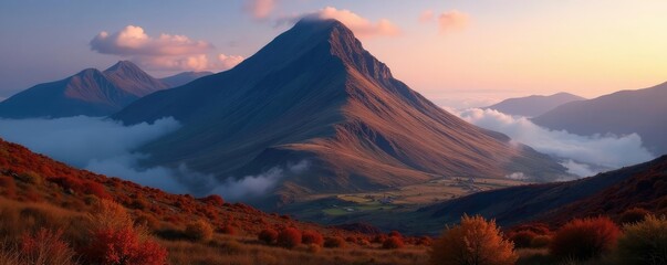 Fototapeta premium Towering peak of Slioch rises high in misty autumn air, dusk, UK