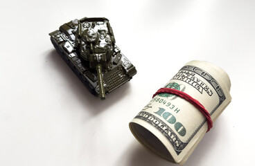 Military tank, American dollar bills. Concept: military and financial assistance to Ukraine, high arms costs, arms supplies from America.
