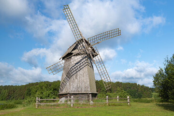 Old wooden windmill on a sunny June day. Mikhailovskoye estate. Pushkin Hills, Russia