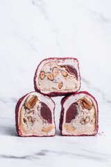 Vegan Turkish delight on a light background, Turkish delight with nuts, almonds, pistachios, dried...