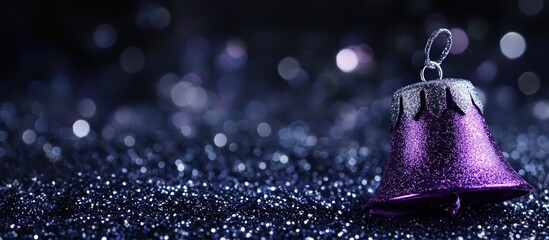 Purple Christmas bell on black glitter background with selective focus emphasizing festive decor and space for text or holiday themes