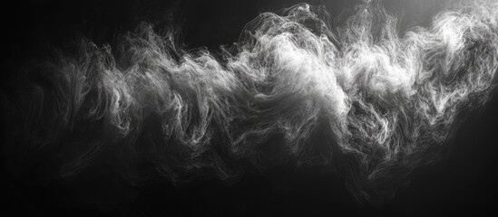 Naklejka premium Swirling wisps of smoke in a dark background creating a mystical and ethereal atmosphere for artistic and design purposes.