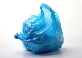 Fototapeta premium A lone blue plastic bag, stark against a white background. Minimalist studio photography emphasizes texture and form.