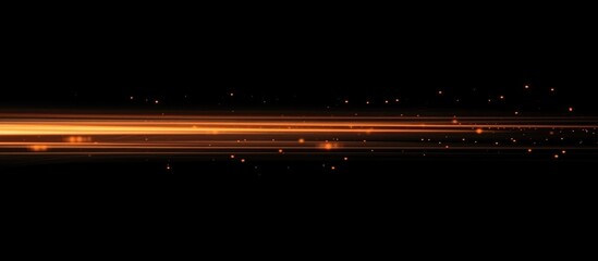 Abstract glowing orange light streaks on a black background creating a defocused ethereal effect for artistic compositions and design.