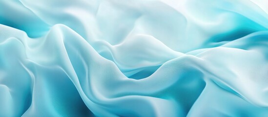 Obraz premium Smooth aqua blue silk fabric texture ideal for elegant backgrounds and designs. Perfect for fashion and luxurious decor projects.