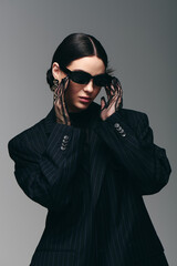 Stylish young woman poses dramatically in modern fashion setting