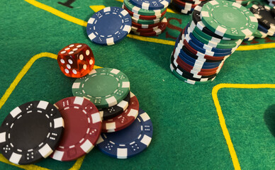 Poker Chips on a gaming table with dramatic lighting