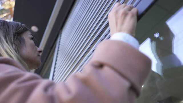 Female Business Owner of Local Store opening garage storefront