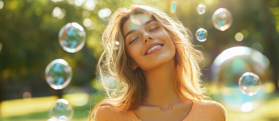 Woman basking in sunlight outdoors with soap bubbles and space for custom text in a serene park setting.