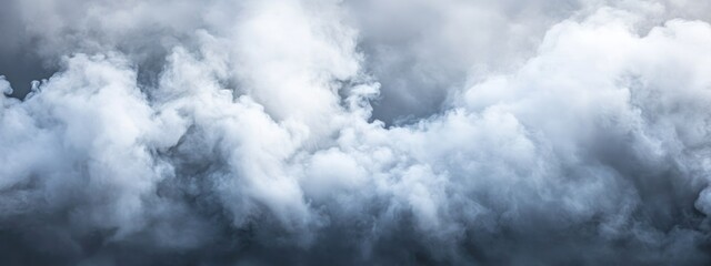 Obraz premium Waves of thick mist and fog swirling against a dramatic cloudy sky with ample space for text or graphics.