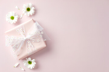 Flat lay composition with gift box and chamomile flowers on pastel pink background. Happy Mother's Day, birthday, International women's Day 8 march concept