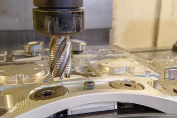 The CNC milling machine cutting  aluminum automotive part by rough cutter tools