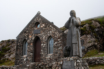 The stone chapel Cillin Phadraig and statue of St. Patrick at the Mam Ean pass in West Ireland.