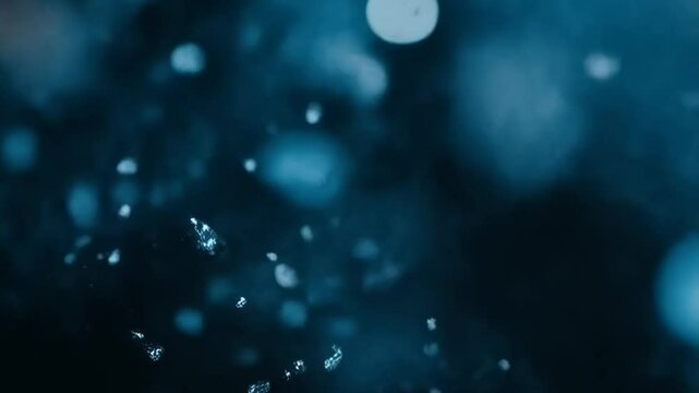 Blue water drops falling in slow motion. Abstract background for design.
