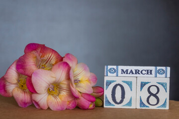 Concept of greeting card on March 8 International Women's day with wooden calendar decorated with...