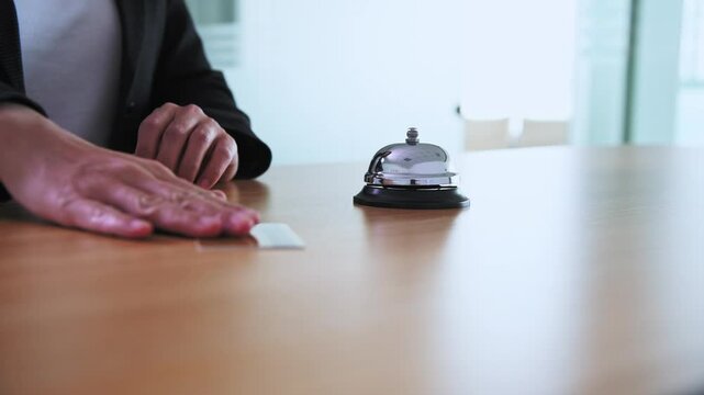 Businesswoman hand using a hotel bell