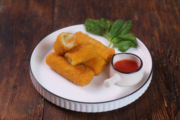 vegetables risoles or risol sayur or risoles sayur stuffed with veggies and enclosed in crepe-like wrappers and rolled into bread crumbs and fried. served on white plate and chili. selected focus	appe