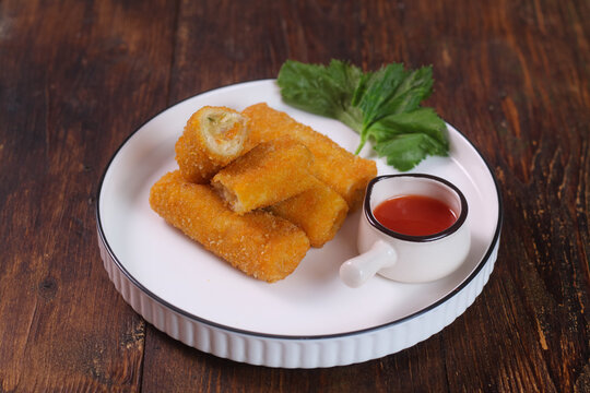 vegetables risoles or risol sayur or risoles sayur stuffed with veggies and enclosed in crepe-like wrappers and rolled into bread crumbs and fried. served on white plate and chili. selected focus	appe