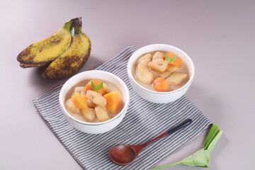 Kolak pisang is Indonesian traditional dessert made of banan and sweet potato with palm sugar sauce. Selective focus
