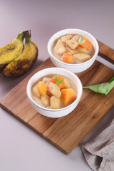 Kolak pisang is Indonesian traditional dessert made of banan and sweet potato with palm sugar sauce. Selective focus
