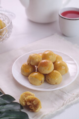 Kue nastar or pineapple tart. indonesian eid snack. on a white plate. bright mood style. perfect for recipe, article, catalogue, or any commercial purposes.
