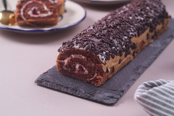 Chocolate Sponge rolls filled with jam and cream and chocolate topping, tastes sweet, soft and delicious,selective fosus,soft focus texture