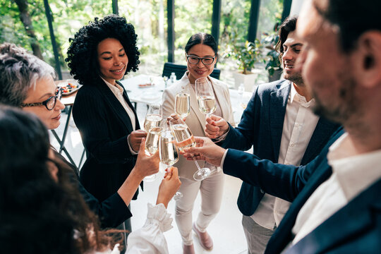 Businessmen and businesswomen making a corporate party after the business conference to celebrate the year goals and achievements.