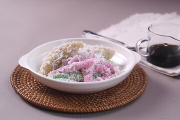 Indonesian traditional dessert,Cenil and Lopis. Cenil is steamed sweet tapioca flour. Lopis is Sweet Cake Made of Glutinous Rice. served with palm sugar and coconut grated.
