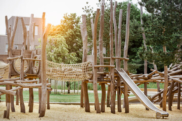 Playground Wood Equipment on Nature Background. Modern Children Wooden Play Equipment with Slide,...