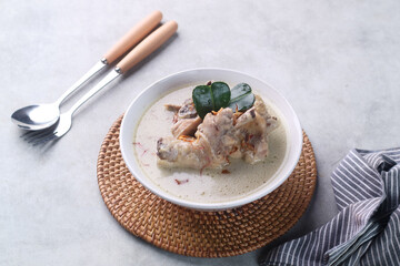 Opor Ayam, Indonesian traditional chicken curry,. made from chicken cooked with coconut milk and spices. Popular to celebrate Eid Fitr, serving with ketupat (rice cake) and sambal goreng
