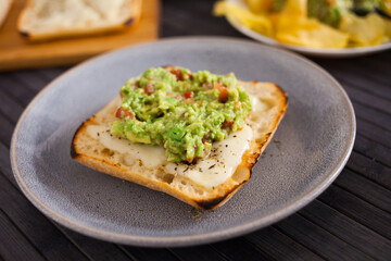 Morning toast with melted cheese and guacamol