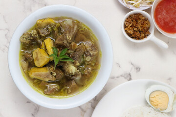 Delicious Indonesian Soto Kambing: Aromatic Lamb Soup with Rice and Egg