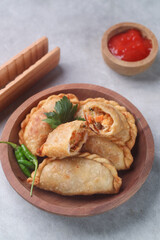 Pastel goreng or chicken and vegetables fried puff is one of the very famous Indonesian snacks
