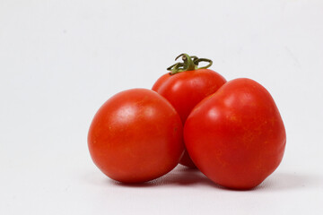 Three Juicy Red Tomatoes on White Background