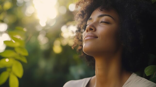 Serene African American Woman Enjoying Sunlight and Nature's Tranquility