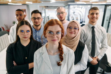 A group of business professionals standing together, taking a well-deserved break from their busy workday, showcasing camaraderie, teamwork, and a moment of relaxation in their dynamic workplace