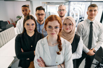 A group of business professionals standing together, taking a well-deserved break from their busy workday, showcasing camaraderie, teamwork, and a moment of relaxation in their dynamic workplace