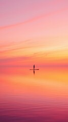 Fototapeta premium Paddleboarder at sunset in calm water; vibrant sky reflection for mindfulness ads