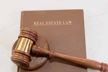 Wooden gavel on law book resting on table