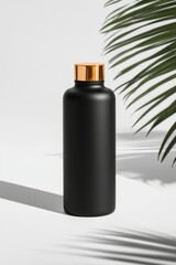 Mockup Black bottle with golden cap on white surface and plant shadow