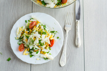 Chinese cabbage salad with squid, eggs, tomatoes and other vegetables