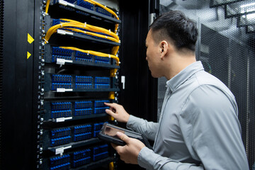 asian male engineer working in database