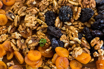 Background of prunes, dried apricots and nuts on a wooden table