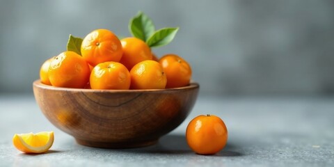 A wooden bowl brimming with vibrant, juicy citrus fruits, a single, ripe fruit rests nearby, showcasing the freshness and abundance of this healthy treat.