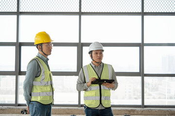 two asian male engineer working in construction site