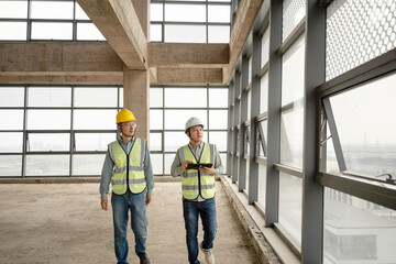 two asian male engineer working in construction site