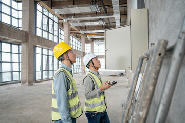 two asian male engineer working in construction site